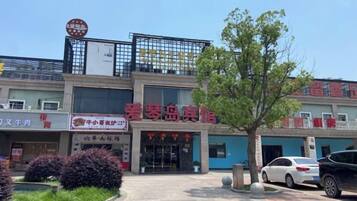 A building with multiple storefronts, including one with a sign that reads 'Love Island Resort.'