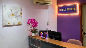 A reception desk with a purple wall, a sign reading "ROYAL HOTEL", and an air conditioning unit above it. - ROYAL HOTEL by MR VJ Business (Kuantan)