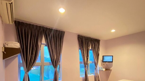 A hotel room with two beds, a TV, and a window with curtains. - ROYAL HOTEL by MR VJ Business (Kuantan)