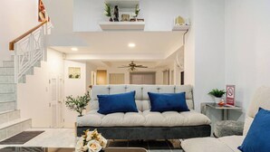 A modern living room with a sofa, coffee table, and a staircase. - New reno, 2 bed townhouse, best location, Patong (Pa Tong)