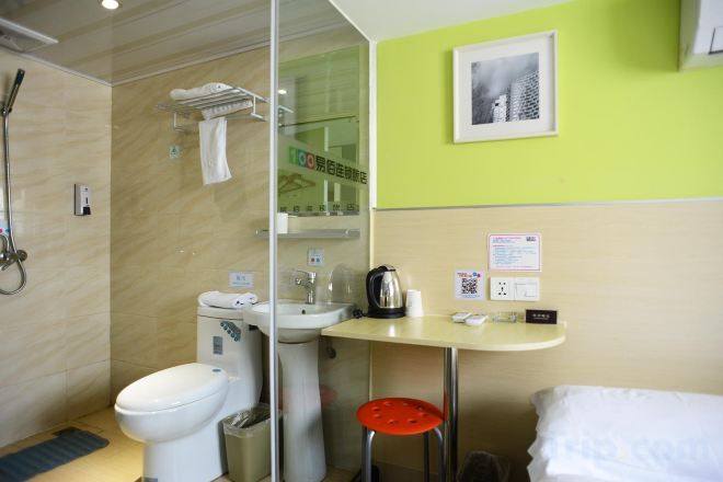 A bathroom with a toilet, sink, and shower.