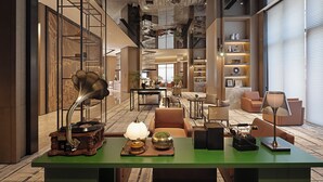 A spacious lobby with a green reception desk, vintage telephones, and modern lighting fixtures. - Wanda Yi Wuhan (Wuhan)