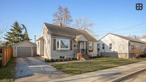 A single-story house with a garage, a front porch, and a small front yard.