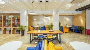 A modern interior with a central dining table, seating, and a children's play area. - Chonpines Hotel (Shengyang Provincial Government, Changjiang North Street, Beilin) (Shenyang)