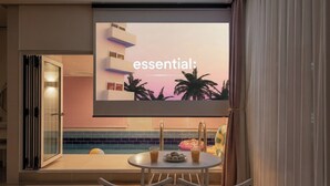 A modern hotel room with a large TV screen displaying 'essential:' and a pool area with a table and chairs. - Gapyeong Reflex Pool Villa Pension (Gapyeong)