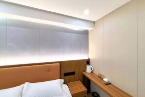 A hotel room with a bed, bedside table, and a nightstand with a lamp. - Youth Hotel (Beijing Temple of Heaven West Gate) (Beijing)
