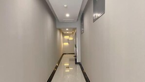 A hallway with a polished floor and recessed lighting. - Beijing Bo'an Chain Hotel (Sanlihe Children's Hospital) (Beijing)