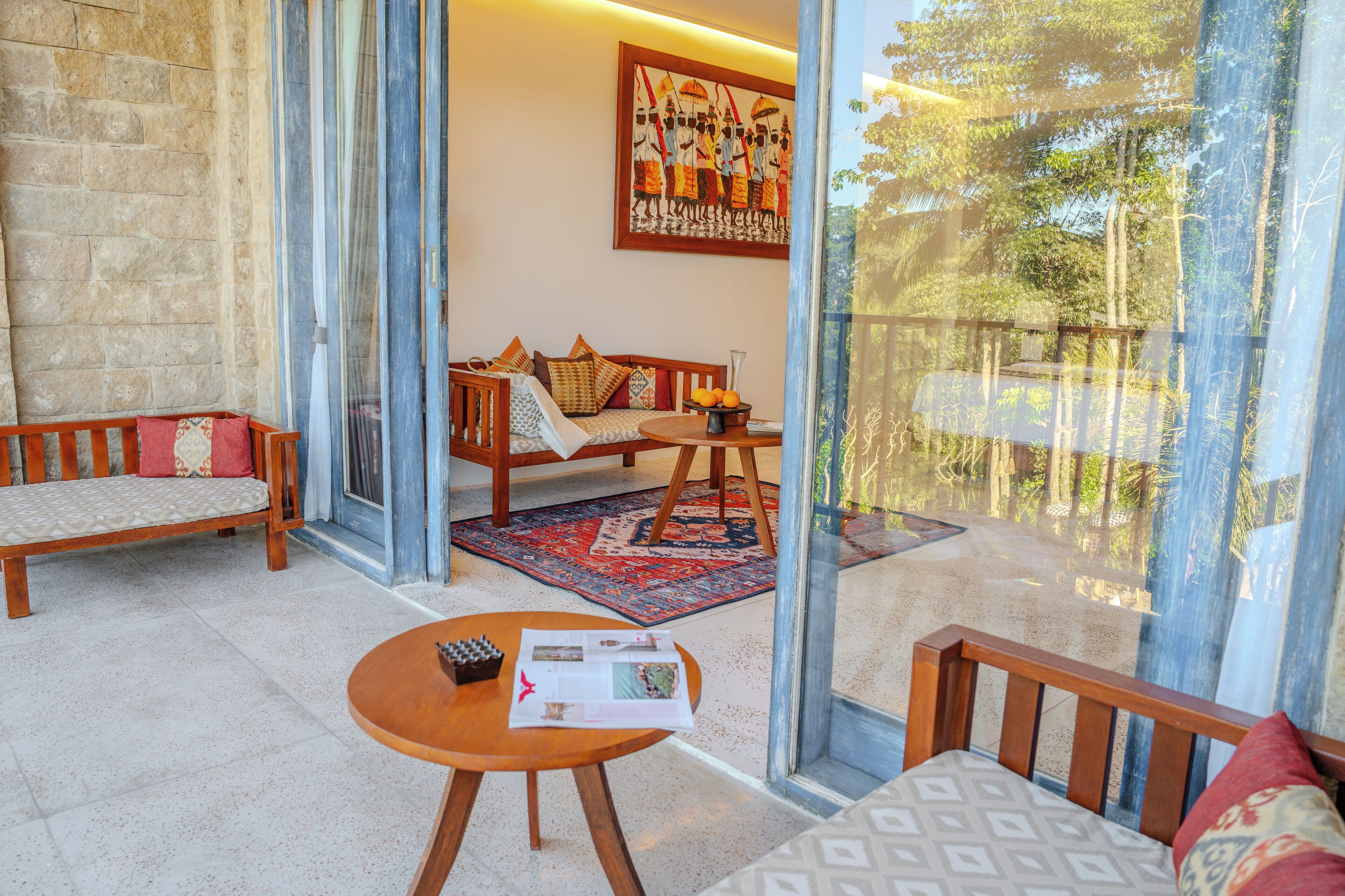 A cozy room with a sofa, a wooden table, and a rug.