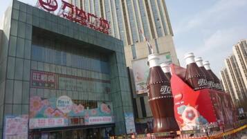 A modern building with a large Coca-Cola advertisement.