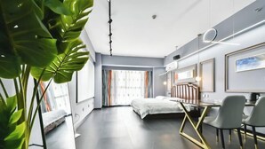 A modern hotel room with a bed, desk, chairs, and a large window. - Jinmei Hotel (Yuhua Wanda) (Shijiazhuang)