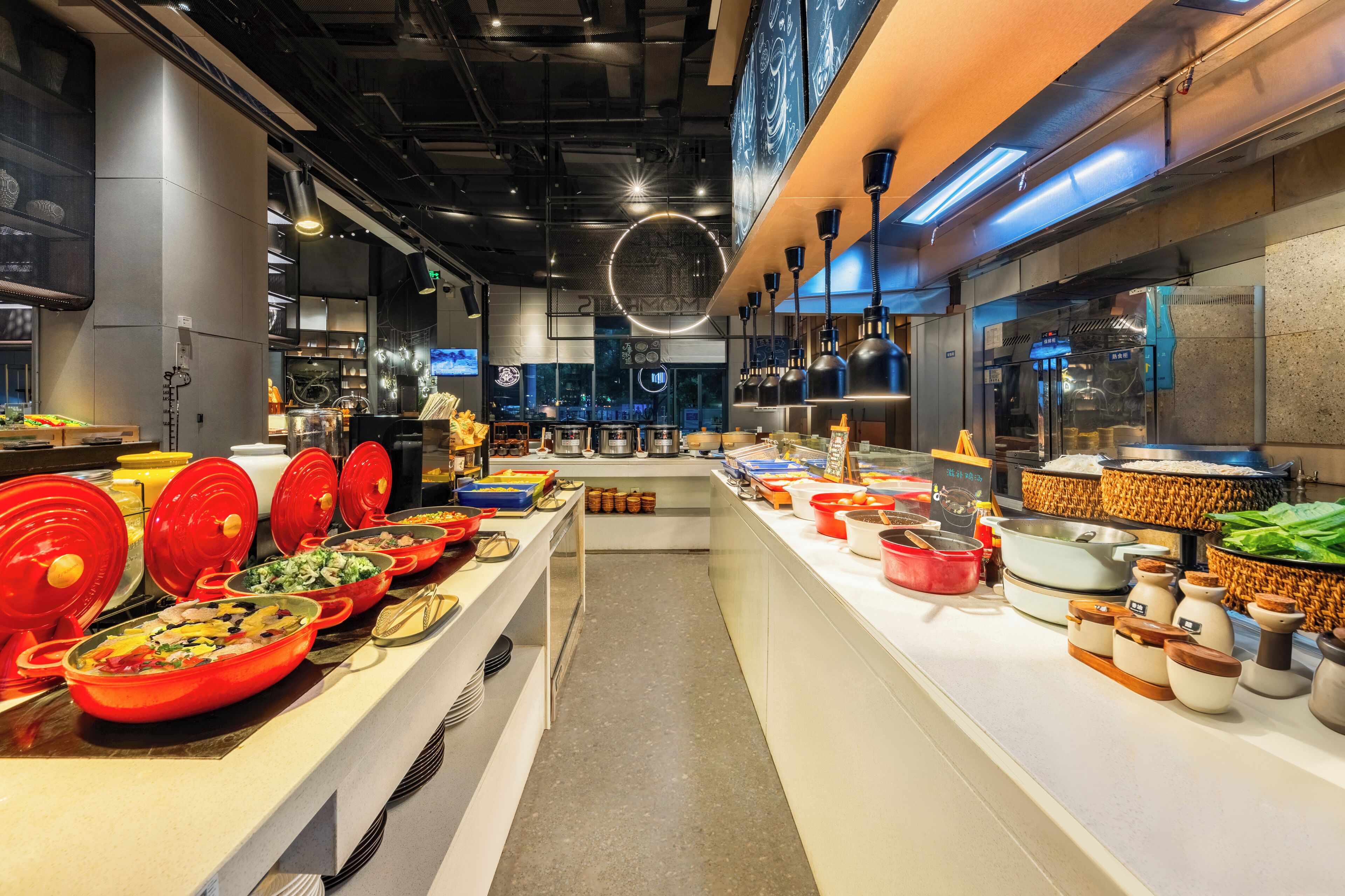 A buffet setup with various food items and serving utensils.