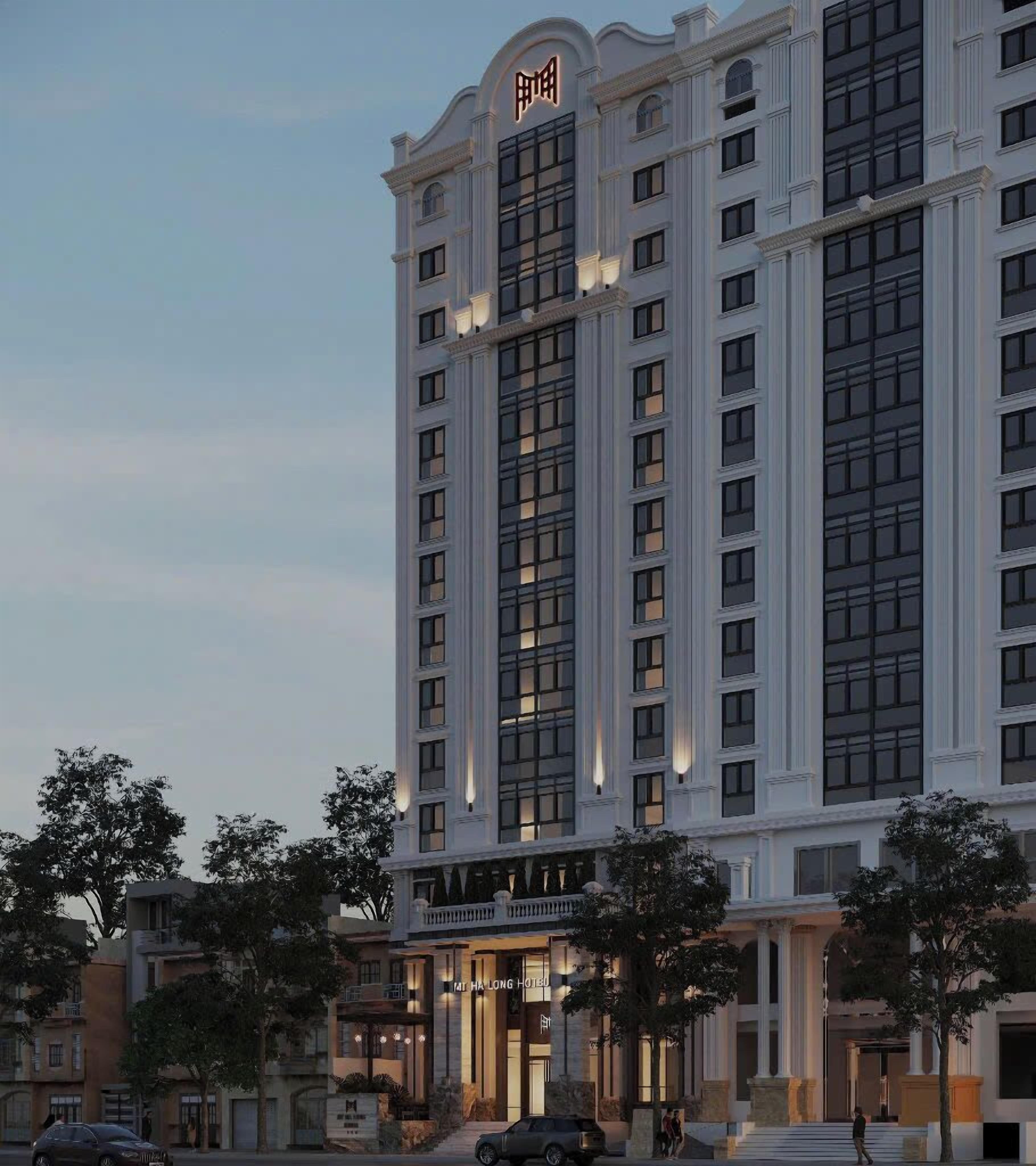 Un hotel de varios pisos con un diseño arquitectónico clásico, que cuenta con una entrada destacada y un letrero grande en la parte superior.