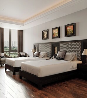 A modern hotel room with two beds, a large window with a city view, and artwork on the walls. - MT Collection Hotel Ha Long (Ha Long)