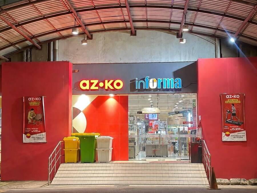 A store entrance with a red awning, signage for 'az-ko inform', and a staircase leading up.