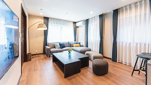 Una sala de estar moderna con un sofá, una mesa de centro y un televisor.
