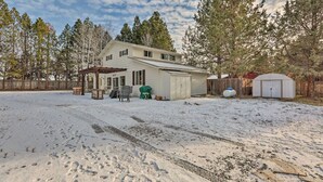 A house with a garage, a covered patio, and a fenced yard. - Cozy Farmhouse on 1 acre- Stargaze in the Hot tub (Bend)