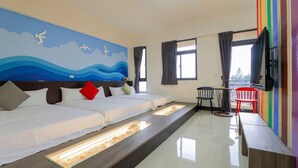 A hotel room with two beds, a small table with chairs, a TV, and a mural on the wall. - XIA XIA JIAO HOMESTAY (Magong)