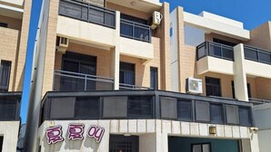 A two-story building with a sign reading "夏夏" on the ground floor. - XIA XIA JIAO HOMESTAY (Magong)