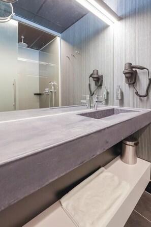 Enjoy a refreshing bathroom experience with a long sink and large mirror, plus convenient towel storage and hair dryers.