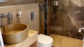 Regadera, secadora de cabello, toallas, papel de baño