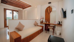 A modern bedroom with a wooden bed, a desk, and a chair. - OhJulia Hotel Komodo (Labuan Bajo)