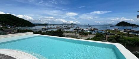 A swimming pool with a view of a marina and boats.