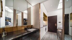 A modern bathroom with a large mirror, a sink, and a toilet. - CitiGO Hotel Shenzhen Shekou  (Shenzhen)