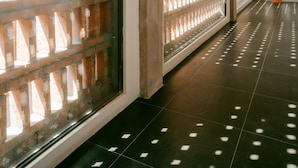A corridor with a brick wall and a glass partition. - Cloud 9 Hotel (Luoyang)