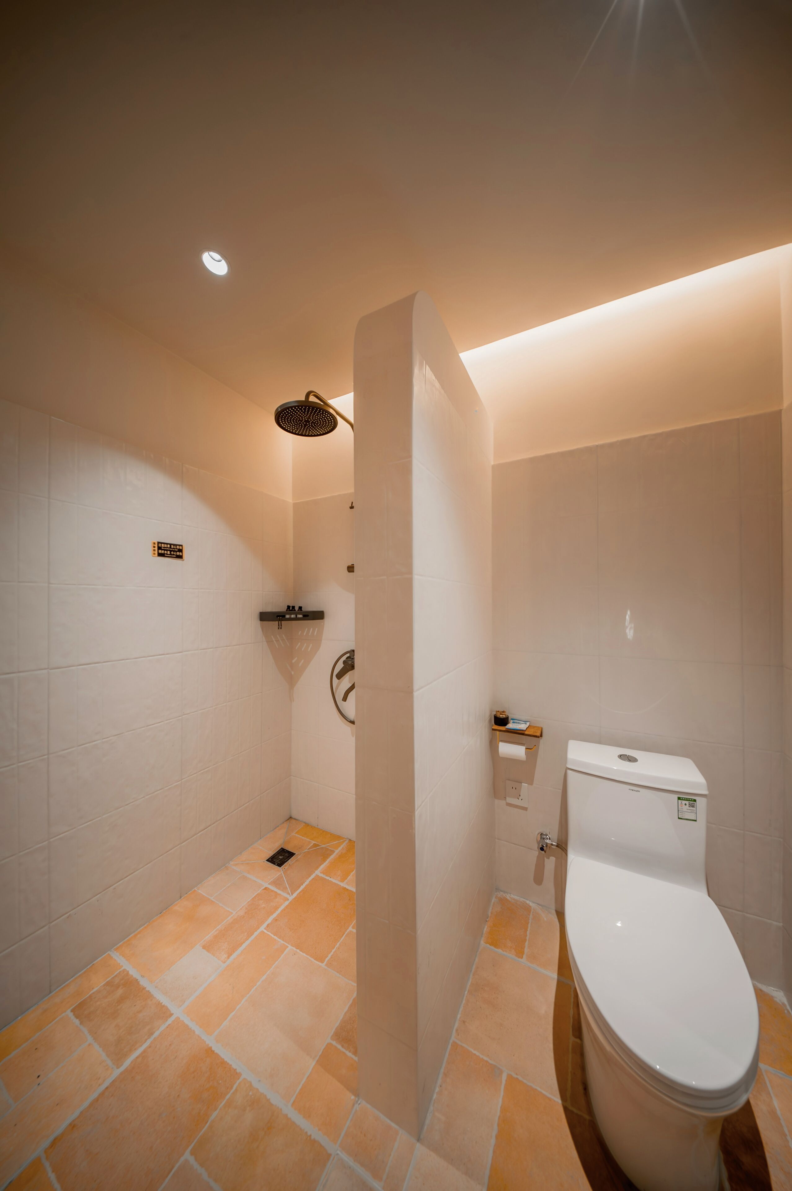 A modern bathroom with a toilet, shower, and sink.