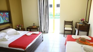 A hotel room with a bed, a chair, a desk, and a mirror. - Porto Plazza Hotel (Hersonissos)