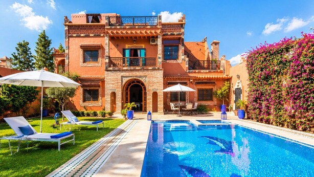 A two-story building with a swimming pool, outdoor seating, and a garden. - Luxurious Aghmat Villa With Private Pool and Panoramic Mountain Views (Ourika)