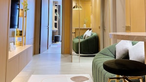 A modern interior with a sofa, a small table, and a wall-mounted air conditioner. - Premium Luxury Menara Jakarta Residence (Jakarta)