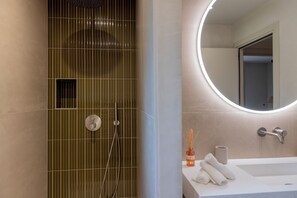 A bathroom with a shower, a sink, a mirror, and a towel rack. - Villa with swimming pool, near Lozari beach – Corsica (BELGODÈRE)