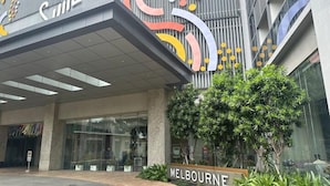 A hotel entrance with a modern design, featuring a large 'CITE' sign and a 'MELBOURNE' sign.