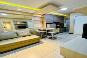 Deluxe Apartment, 2 Bedrooms, Balcony, City View | Living area | 42-inch flat-screen TV with cable channels
