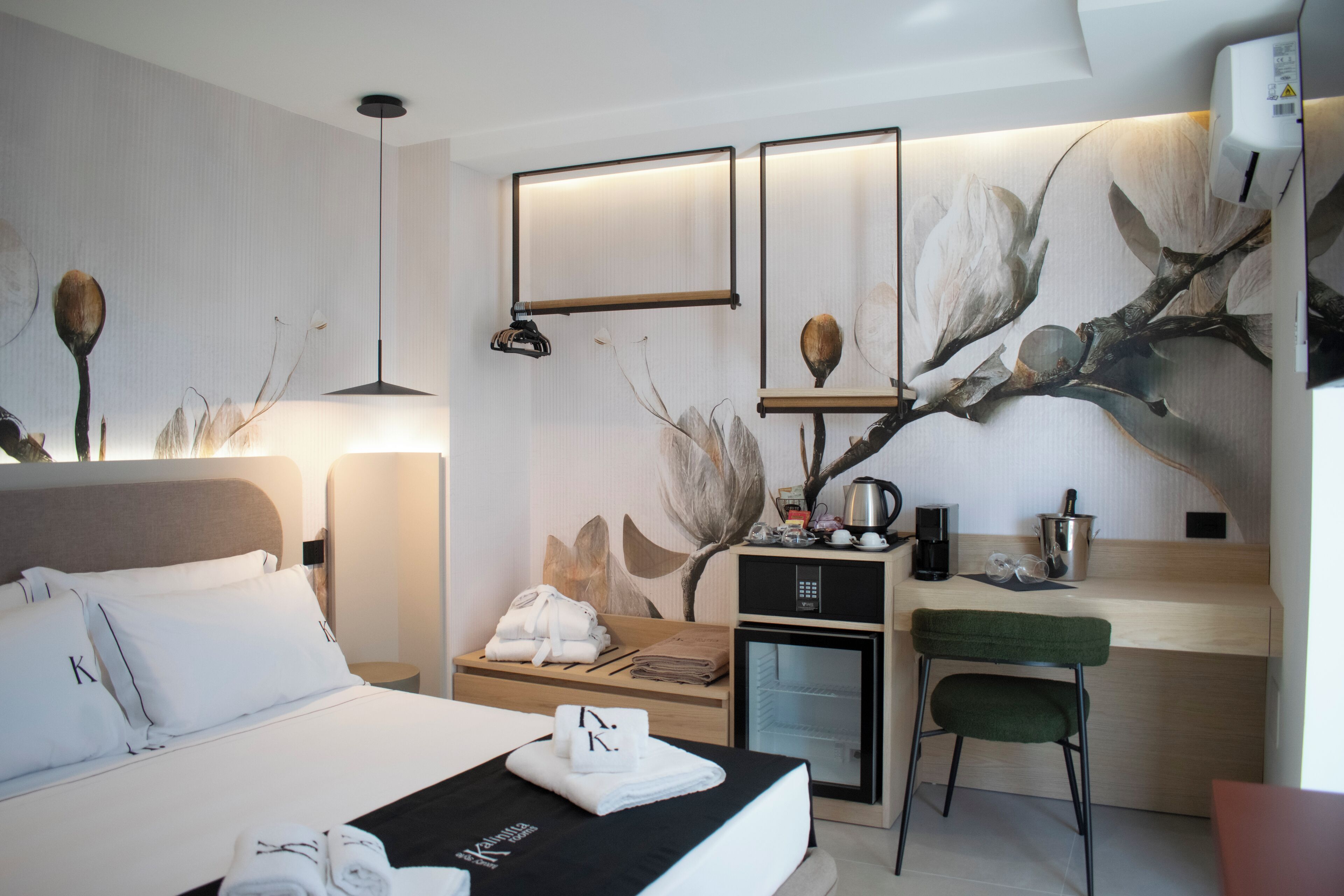 A hotel room with a bed, a desk, a chair, a coffee maker, and a microwave.