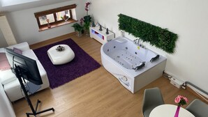 A modern bathroom with a freestanding bathtub, a vanity, and a window with a view.