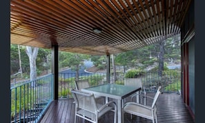 Relax in this serene outdoor seating area surrounded by lush greenery.