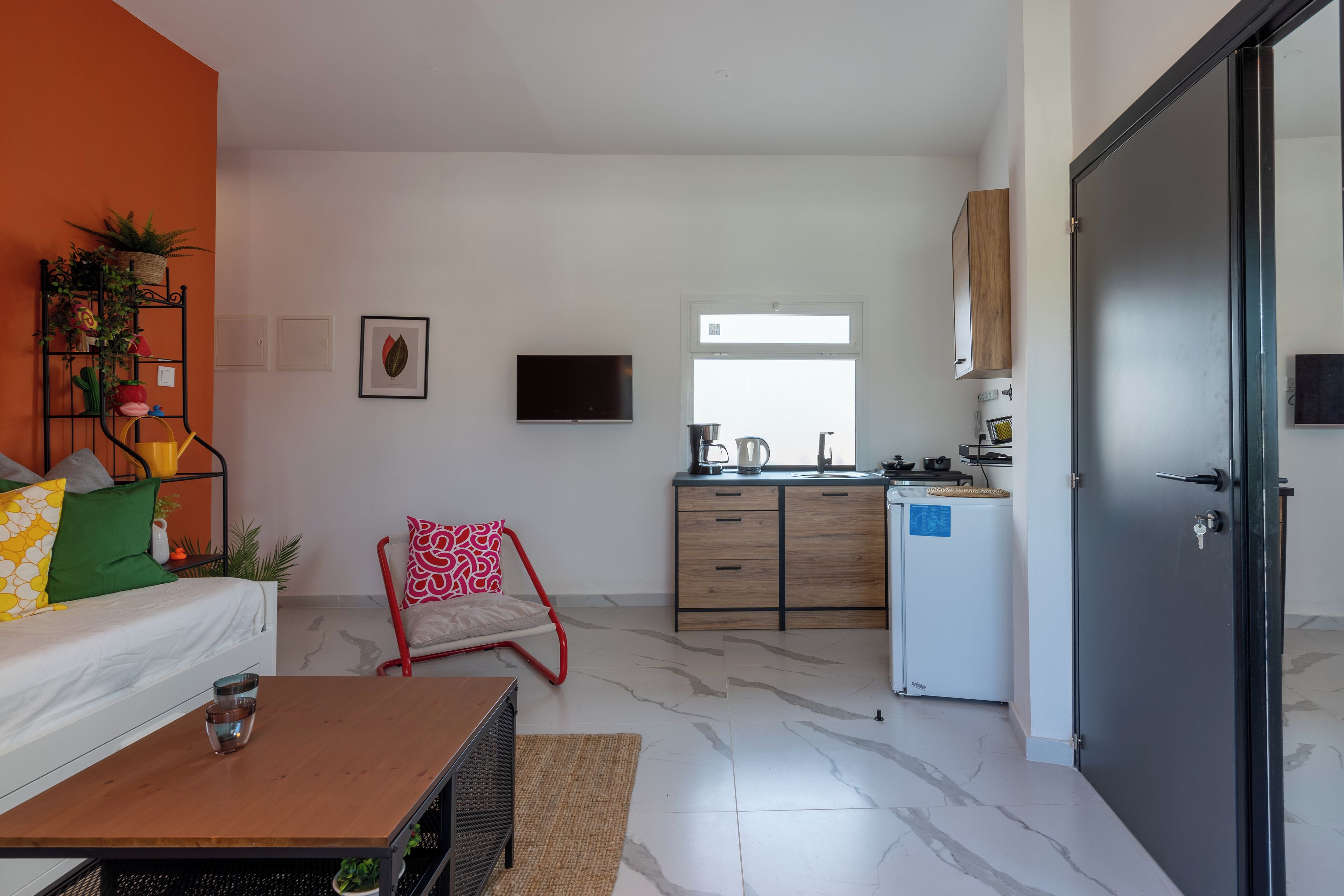 A modern apartment with a living room, kitchen, and a dining area.