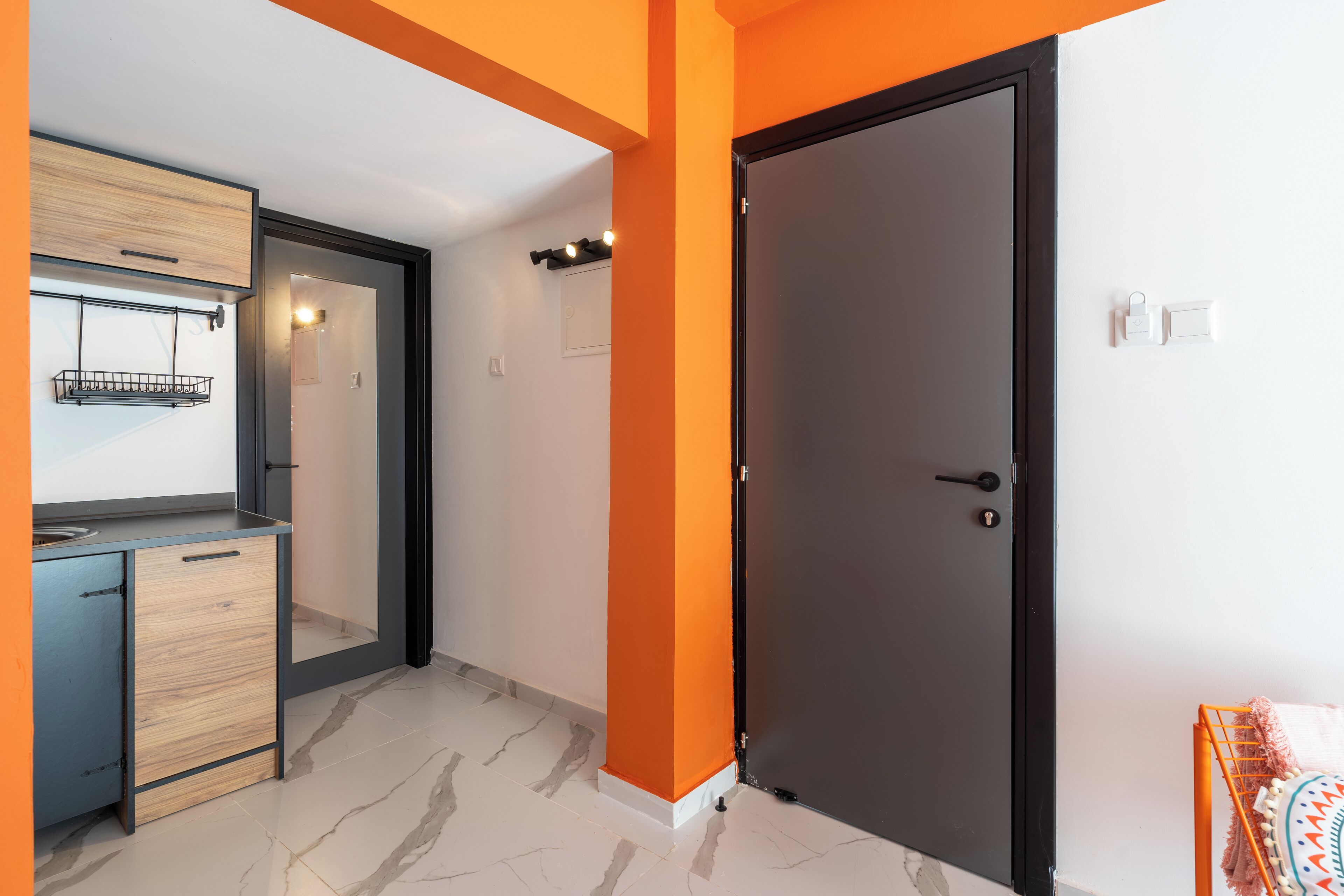 A modern kitchen with a built-in oven, a wooden cabinet, and a countertop.