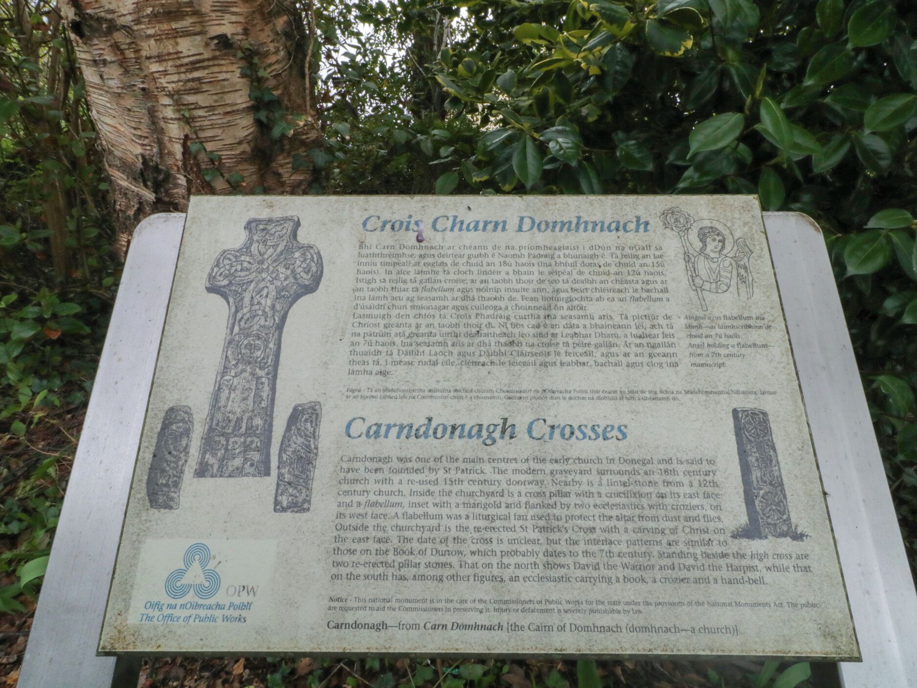 A historical marker detailing the Crois Carmn Domhnach and Carndonagh Crosses, with descriptions of their significance and features.