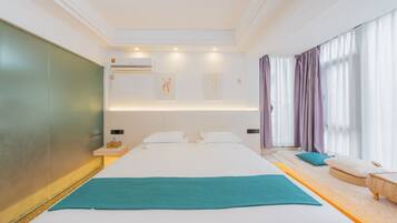 A modern hotel room with a large bed, a bedside table, a wall-mounted air conditioner, and a window with curtains.