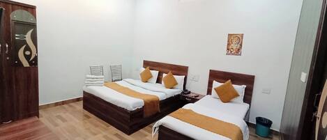 Deluxe Triple Room, City View | Desk, laptop workspace, soundproofing, bed sheets