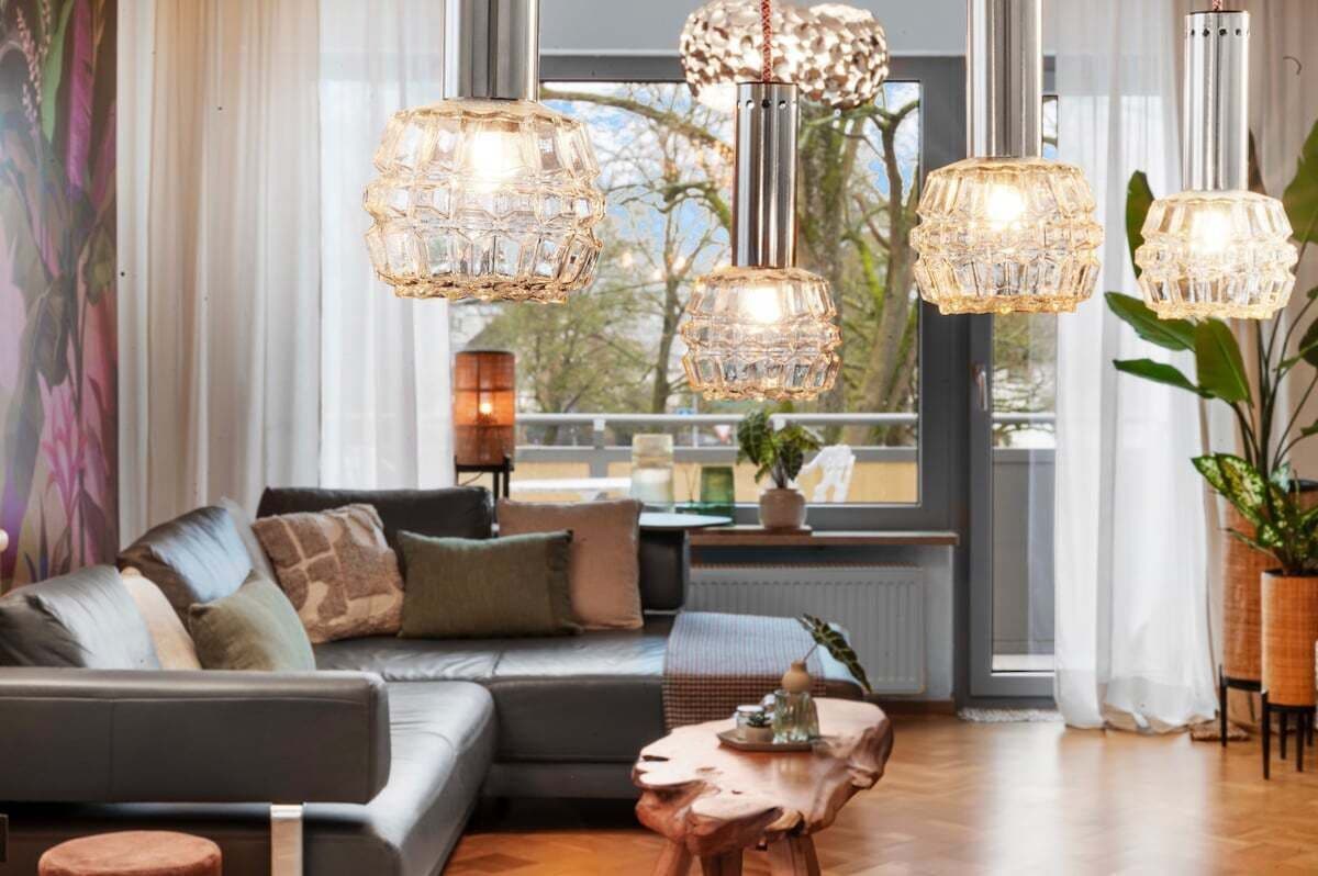 A modern living room with a sofa, coffee table, and decorative lights.