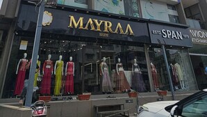 A multi-story building with various businesses including a hotel named 'Hotel Nexus Inn AC', a diagnostics center, and a bridal store named 'Mayraa'. - Hotel Nexus Inn (Ahmedabad)
