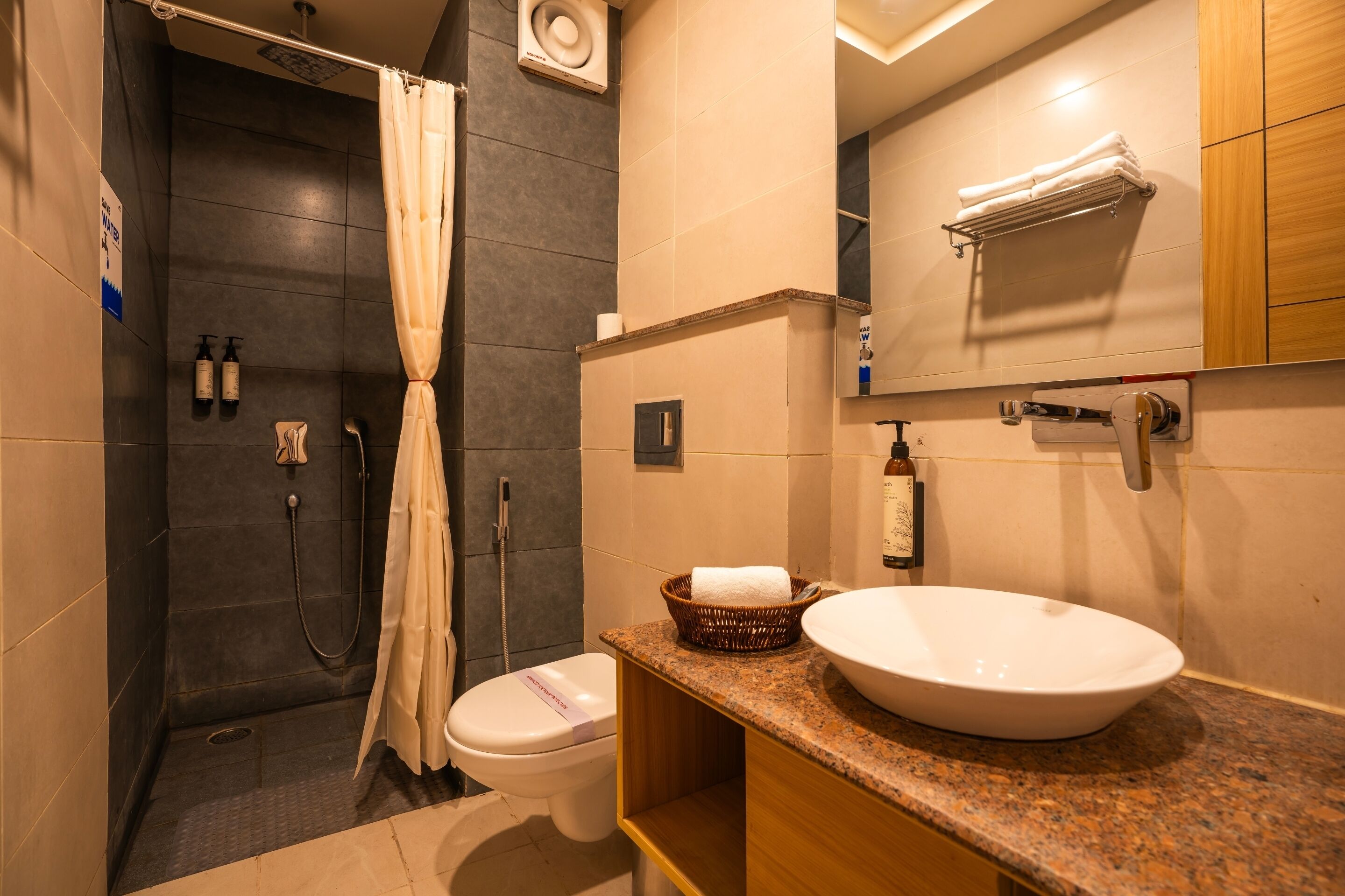A modern bathroom with a shower, toilet, and sink.