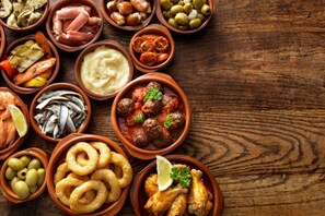 A variety of dishes arranged in terracotta bowls on a wooden table.