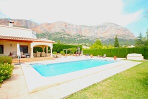 Relax by the rectangular pool surrounded by a paved deck and enjoy the scenic mountain views.