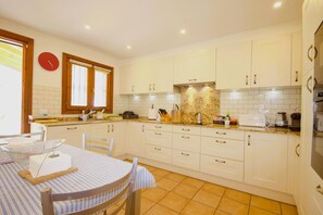 Enjoy cooking in this well-equipped kitchen with oven, coffee maker, and ample storage.