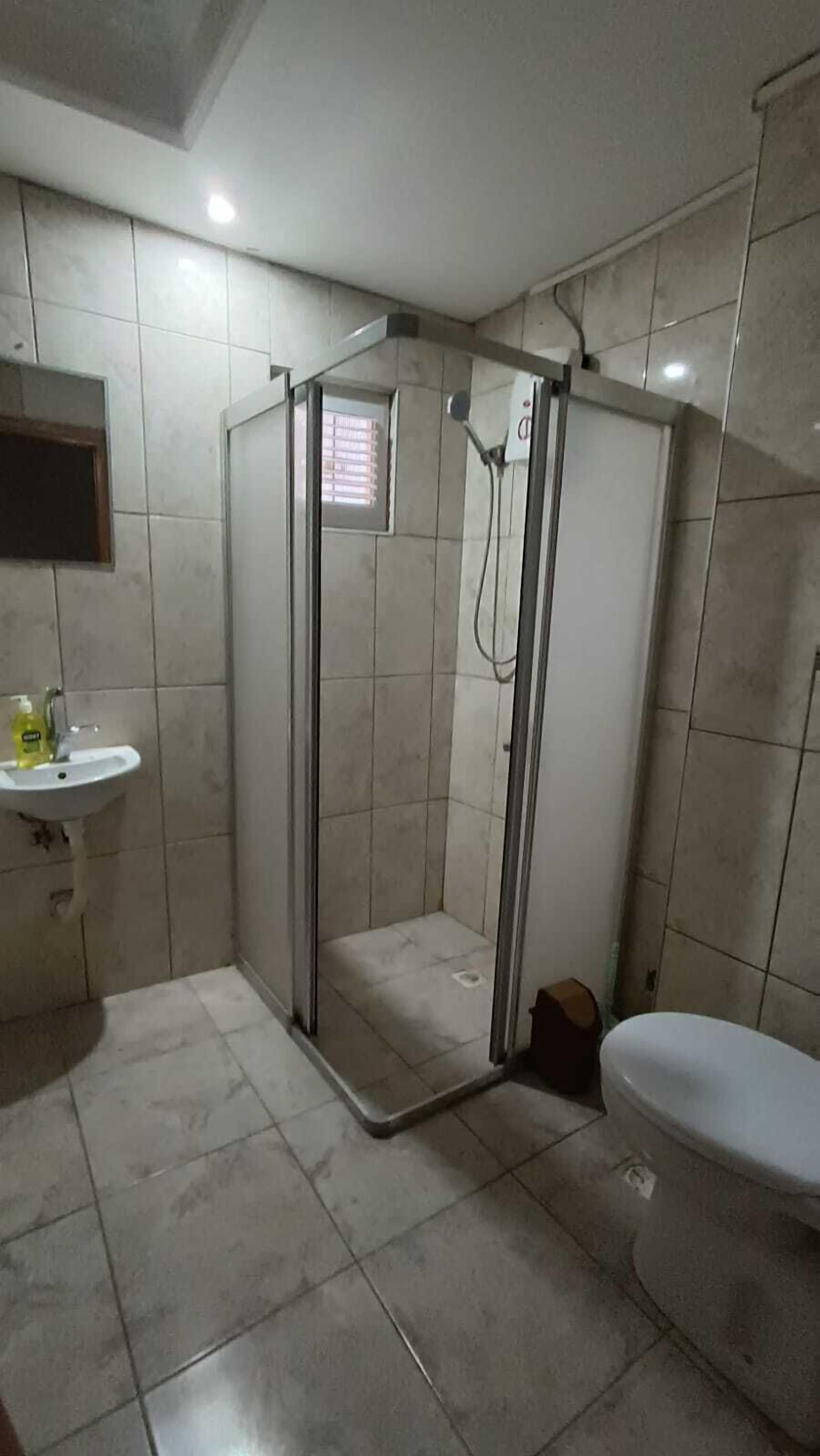 Shower, hair dryer, slippers, towels